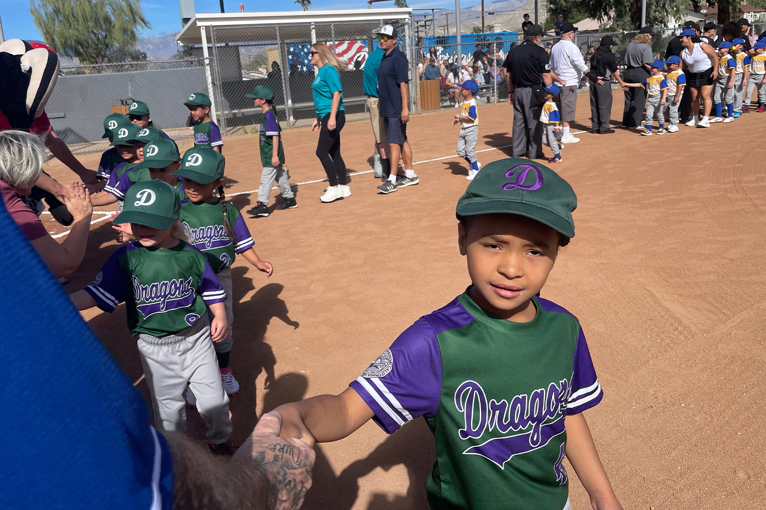 Kids on the Little Leauge team giving high fives to local leaders in Desert Hot Springs.